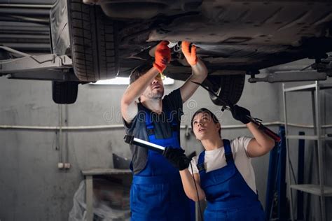 Two Workers Repair A Car And Use A Torch Stock Image Image Of