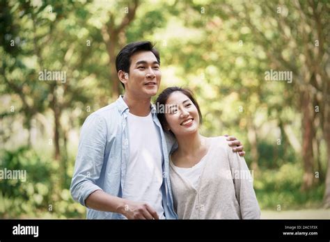Happy Loving Young Asian Couple Relaxing In Park Stock Photo Alamy