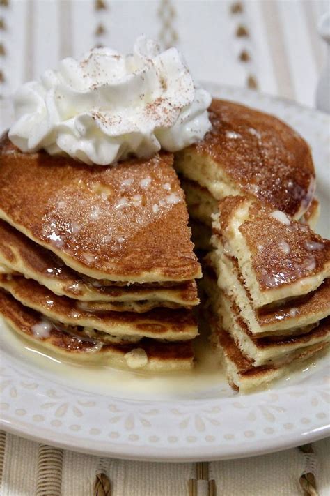 A Stack Of Pancakes With Whipped Cream On Top