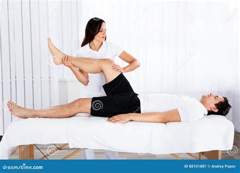 Young Female Masseur Giving Leg Massage To Man Stock Image Image Of Masseuse Health 88101887