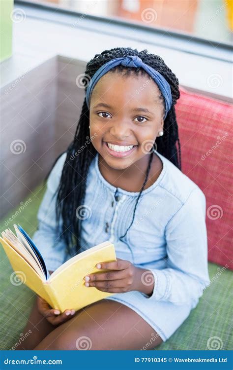 Schoolgirl Sitting On Sofa And Reading Book Stock Image Image Of