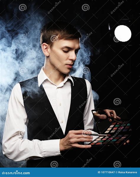 Professional Makeup Artist Posing In Studio Holds A Palette Of Stock