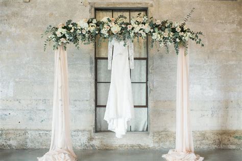 Wedding Ceremony Arch With Blush Draping And Floral Of Giant Eucalyptus