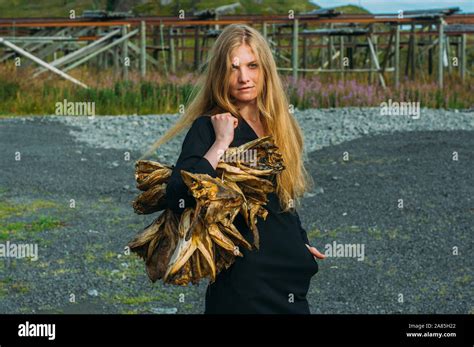Girl In Black Dress With Bundle Of Dried Fish Heads Lofoten Islands