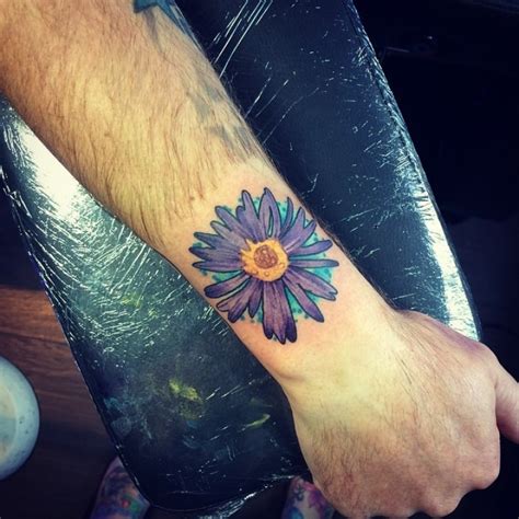 Some of these include innocence, affection, care, and love (any kind, and not just romantic love). Beautiful violet aster flower tattoo on arm - Tattooimages.biz