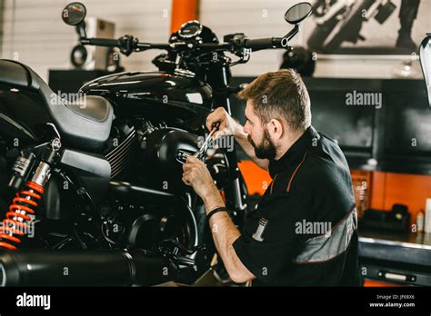 Professional Mechanic Working Screwdriver And Motorcycle Repairs