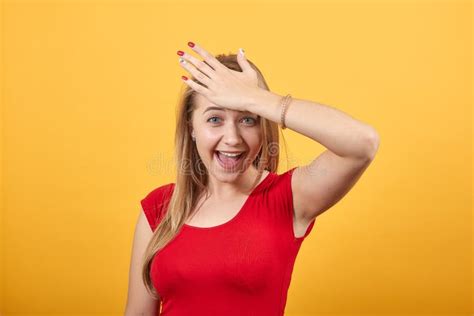 Young Blonde Girl In Red T Shirt Over Isolated Orange Background Shows