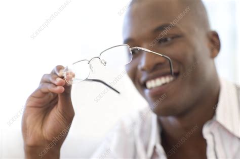 Man Holding A Pair Of Glasses Stock Image F0011093 Science Photo