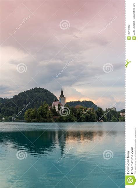 Bled Lake With The Island And Church Blue Water And Storm Clouds