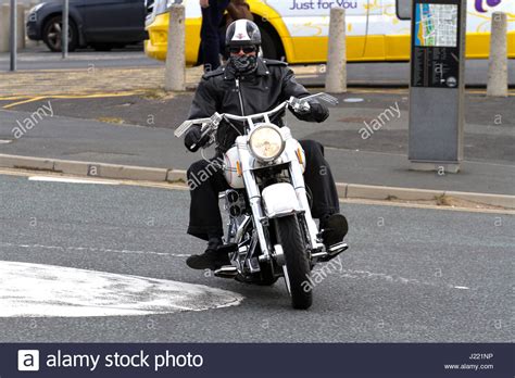A Motorcyclist Rides His Harley Davdison Along Southport Promenade