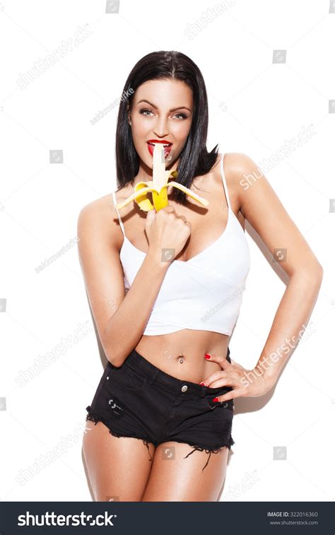 Sexy Brunette Woman Eating Banana Isolated