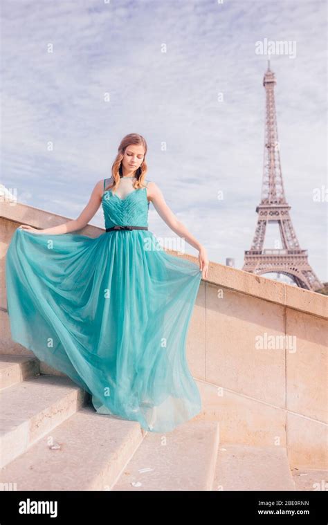 A Girl In Paris In A Green Dress Against The Backdrop Of The Eiffel