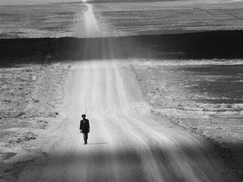 A Man Walking Through The Desert In Little Karoo South Africa