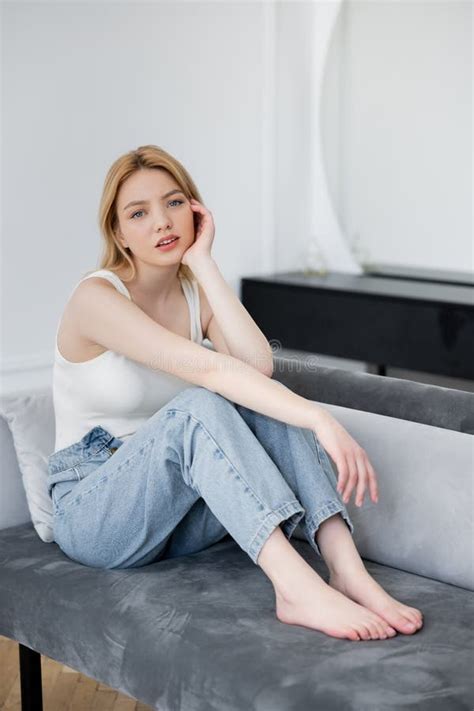 Barefoot Woman In Jeans Looking At Stock Photo Image Of Sofa Pretty