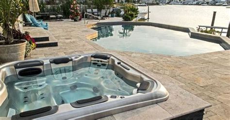 The bathtub creates its own liner for a pond, which simplifies the installation. Turning a Portable Hot Tub Into an Elegant Spa That Looks ...