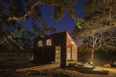 The cabin has one bedroom with a queen bed. Starry night view of Cabin 30 at Spring Lake Campground in ...