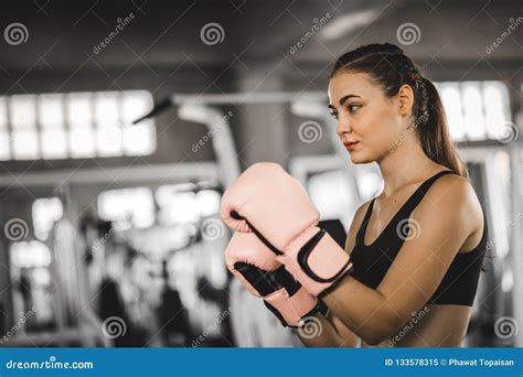 Fit Beautiful Woman Boxer Hitting A Huge Punching Bag Exercise C Stock