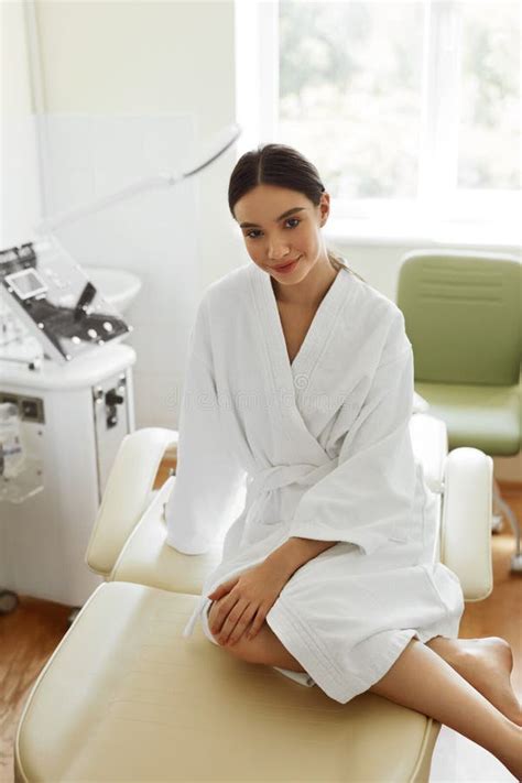 Beautiful Woman In Bathrobe In Cosmetology Room At Spa Salon Stock