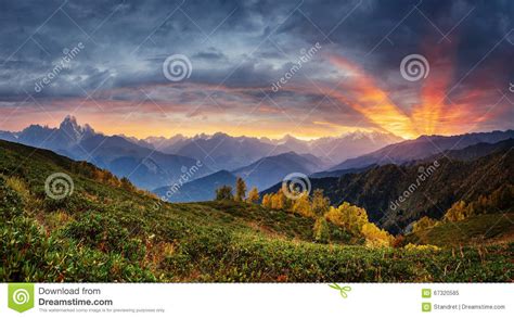 Sunset Over Snow Capped Mountain Peaks Stock Image