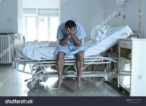 Stock Photo Young Desperate Man Sitting At Hospital Bed Alone Sad And