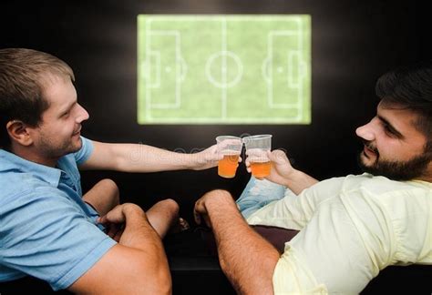 Male Fans Watch Football On Tv And Drink Beer Friends Have A Great Time Drinking Beer Stock