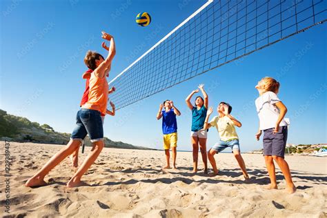 Boys And Girls Playing Volleyball On The Beach Stock Photo Adobe Stock