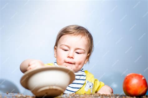 Premium Photo Cute Funny Babies Eating Baby Food Funny Kid Boy With