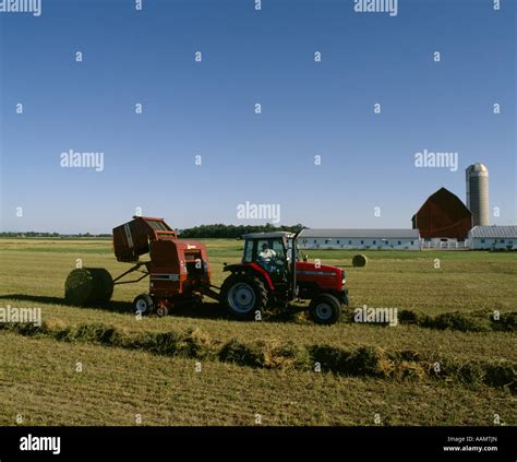Tractor And Baler Harvesting Alfalfa Hay Into Round Bales Tractor And