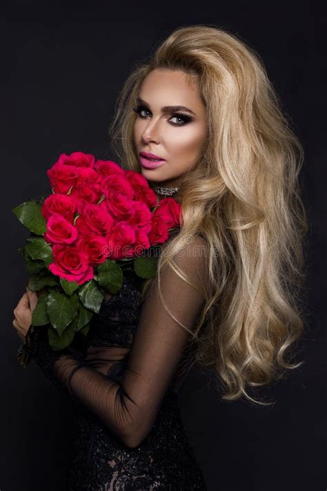 Beautiful Blond Model In Elegant Dress Holding A Bouquet Of Red Roses Valentines`s T On A