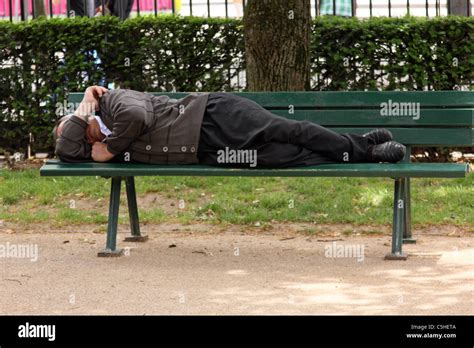 Man Sleeping On A Paris Park Bench Stock Photo Alamy