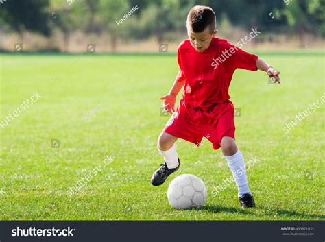 Boy Kicking Soccer Ball On Sports Stock Photo 493821055 Shutterstock