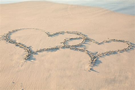 Premium Photo Two Hearts Drawn In The Sand