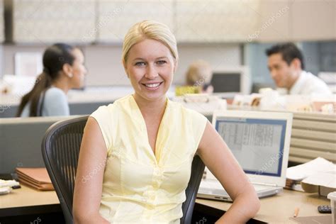 Businesswoman In Cubicle Smiling — Stock Photo © Monkeybusiness 4772011