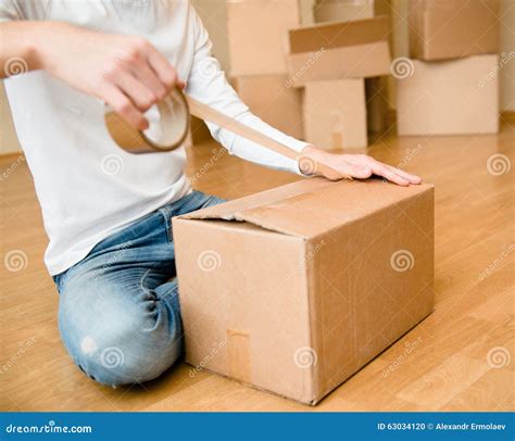 Close Up Of Person Hands Packing Cardboard Box Stock Photo Image