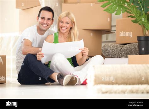 Young Happy Couple Moving Into Their New Home With Plan Stock Photo Alamy