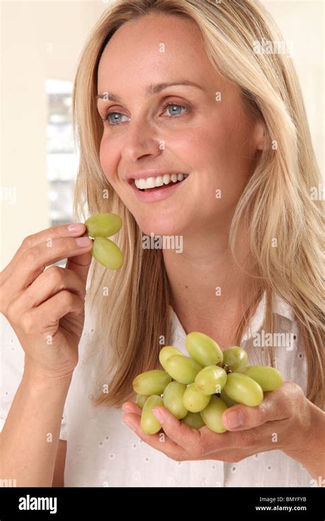 Woman Eating Grapes Stock Photo Alamy