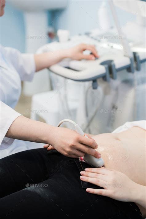 Close Up Of Doctor Moving Ultrasound Probe On Pregnant Womans Stomach