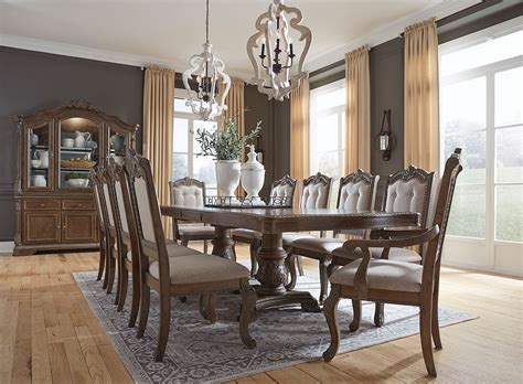 A stylish modern dining room set, set comprises of dining table, dining chair, tall, medium and small shelf units, sideboard, 2 prints, several vases, plant, rug, single voile, baskets for the shelves and sideboard and a half wall in wood and wicker. Charmond Dining Room Set by Signature Design by Ashley ...