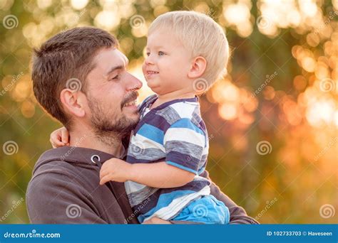 father and son outdoor portrait in sunset sunlight stock image image of park outdoor 102733703