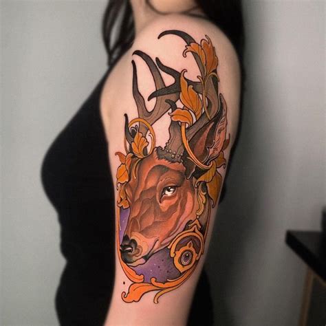 A Woman With A Deer Tattoo On Her Arm