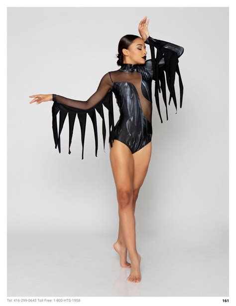 a woman in a bodysuit with black feathers on it