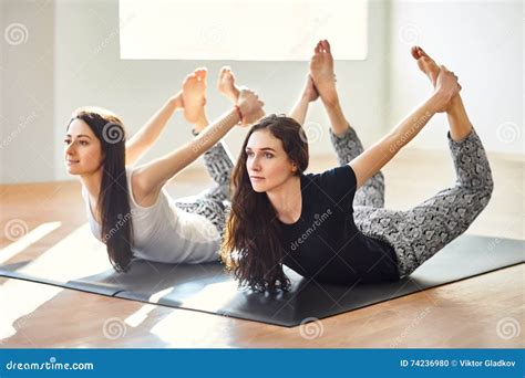 Two Young Women Doing Yoga Asana Bow Pose Stock Photo Image Of