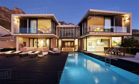 Evening view of a modern house with swimming pool. Modern luxury home showcase exterior and swimming pool ...