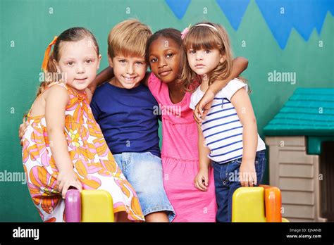 Happy Group Of Kids Embracing In A Kindergarten Stock Photo Alamy