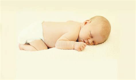 Close Up Portrait Of Infant Sweet Sleeping On White Bed At Home Stock