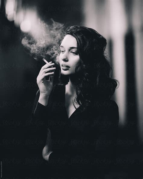beautiful woman posing with a cigarette by stocksy contributor mosuno stocksy