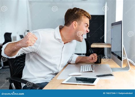 Aggressive Furious Businessman Shouting And Working With Computer In
