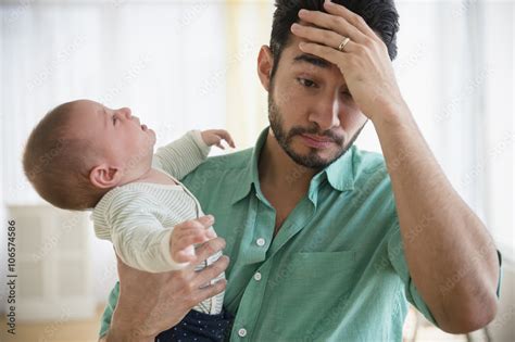 Frustrated Father Holding Crying Baby Stock Photo Adobe Stock