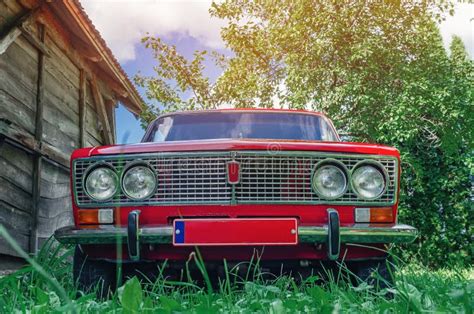 Front View Of A Red Vintage Lada Car In The Countryside Old Wooden