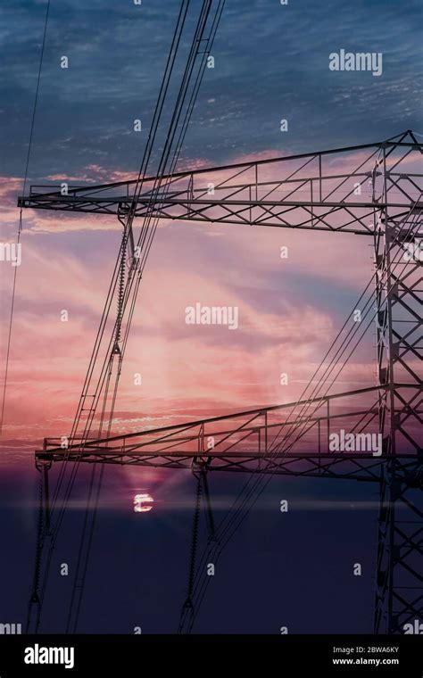 High Voltage Power Lines Electricity Pylons At Sunset Stock Photo Alamy
